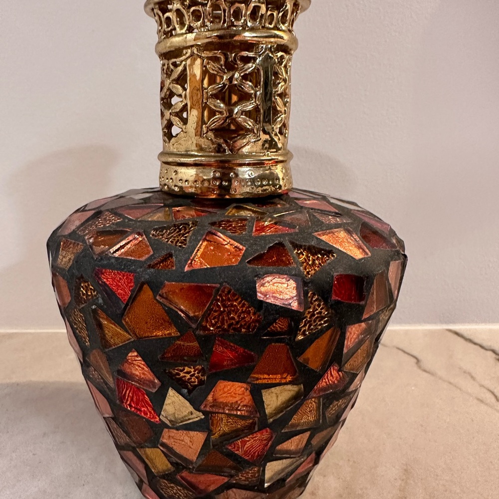 A beautiful glass mosaic Lampe Berger with stone and wick.